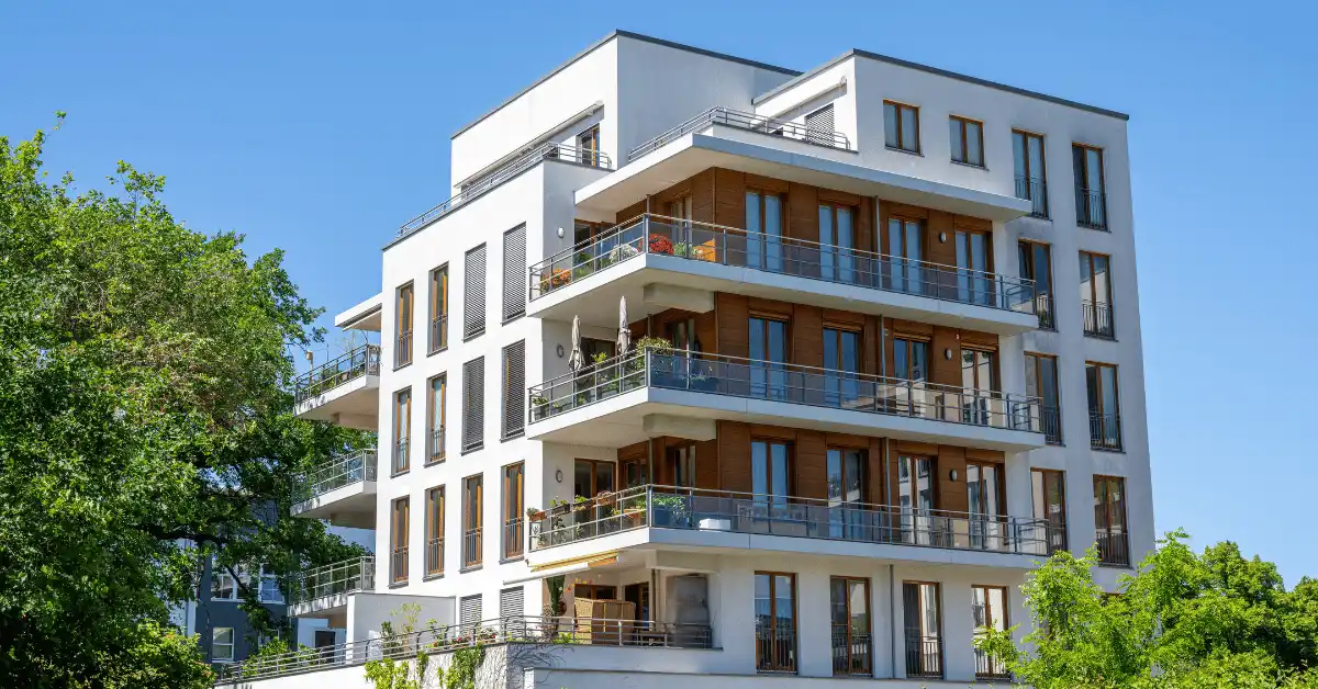 Modern multifamily apartment building with balconies, representing Florida residential construction.