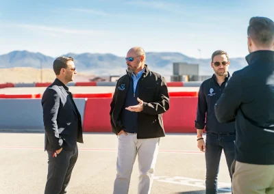 Member of the ELITE Construction team chatting with developers at an exotic racing event in Las Vegas