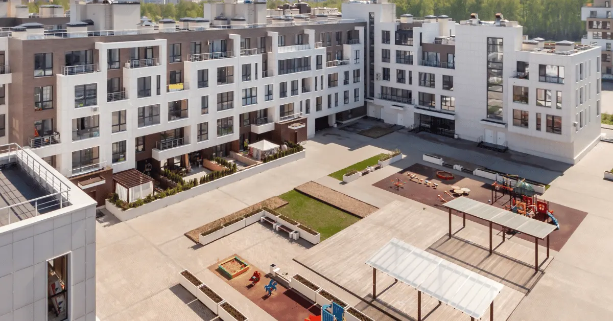 Completed multifamily apartment community with courtyard and outdoor amenities.